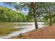 Serene riverfront property with mature trees and tranquil waters at 1053 Riverbend Club Se Dr, Atlanta, GA 30339