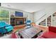 Spacious living area with a fireplace, eclectic decor, and hardwood floors at 1053 Riverbend Club Se Dr, Atlanta, GA 30339