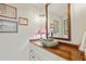 Modern bathroom with a unique stone sink and vintage artwork at 1053 Riverbend Club Se Dr, Atlanta, GA 30339