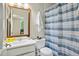 Simple bathroom with a shower/tub combo, and blue and white striped shower curtain at 1053 Riverbend Club Se Dr, Atlanta, GA 30339