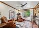 Relaxing sunroom with leather armchairs and access to a deck at 1053 Riverbend Club Se Dr, Atlanta, GA 30339