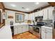 Well-equipped kitchen with white cabinets, stainless steel appliances and terracotta flooring at 1053 Riverbend Club Se Dr, Atlanta, GA 30339
