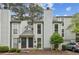 Gray townhome with double doors and a car parked in front at 1053 Riverbend Club Se Dr, Atlanta, GA 30339