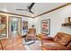 Cozy living room with two leather armchairs, wood floors and a view into the kitchen at 1053 Riverbend Club Se Dr, Atlanta, GA 30339