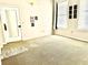 Bright living room featuring large windows and neutral carpeting at 32 Peachtree Nw St # 1006, Atlanta, GA 30303
