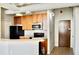Modern kitchen with light wood cabinets and black appliances at 32 Peachtree Nw St # 1006, Atlanta, GA 30303