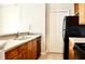 Modern kitchen with light wood cabinets and black appliances at 32 Peachtree Nw St # 1006, Atlanta, GA 30303