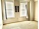 Spacious bedroom with neutral walls, carpeting, and large windows at 32 Peachtree Nw St # 1006, Atlanta, GA 30303