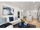 Living area flows into kitchen, featuring a white sectional and island at 201 New St # 2201-9, Decatur, GA 30030