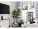Comfortable living room with large TV, sliding glass doors, and plenty of plants at 201 New St # 2201-9, Decatur, GA 30030