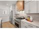 Modern kitchen with wood range hood and stainless steel appliances at 201 New St # 2201-9, Decatur, GA 30030