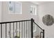 Modern staircase with black metal railing and wall art at 201 New St # 2201-9, Decatur, GA 30030