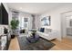 Bright living room with white couch, balcony access, and wood floors at 201 New St # 2201-9, Decatur, GA 30030