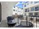 Private balcony with courtyard view and bistro furniture at 201 New St # 2201-9, Decatur, GA 30030