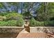 Deck with stone retaining wall and steps leading to yard at 906 Courtenay Ne Dr, Atlanta, GA 30306