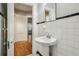Clean bathroom with pedestal sink and view into hallway at 906 Courtenay Ne Dr, Atlanta, GA 30306