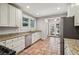 Bright kitchen with granite countertops, stainless steel appliances, and terracotta tile floors at 906 Courtenay Ne Dr, Atlanta, GA 30306