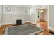 Spacious living room featuring hardwood floors, fireplace, and built-in shelving at 906 Courtenay Ne Dr, Atlanta, GA 30306