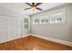 Spacious bedroom with hardwood floors, ceiling fan, and ample closet space at 906 Courtenay Ne Dr, Atlanta, GA 30306