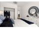 Elegant bedroom with a white upholstered headboard, plush bedding and a large mirror at 201 New St # 2205-1, Decatur, GA 30030