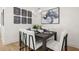 Modern dining area with a sleek dark wood table and white chairs at 201 New St # 2205-1, Decatur, GA 30030