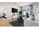Bright living room with modern furniture and hardwood floors, showcasing a view of a bedroom at 201 New St # 2205-1, Decatur, GA 30030