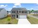 Two-story brick home with a large driveway and landscaped yard at 536 Whitman (2010) Ln, Stockbridge, GA 30281