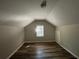 Charming bedroom with sloped ceilings and a large window at 1904 Sandtown Sw Rd, Atlanta, GA 30311