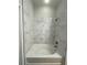 Bathroom with a bathtub and marble-look tile at 425 Chapel Sw St # 1206, Atlanta, GA 30313