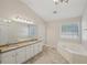 Bathroom with double vanity, granite, and tub at 4011 Lafayette Way, Loganville, GA 30052