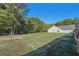 Large backyard with home's side elevation and fence at 4011 Lafayette Way, Loganville, GA 30052