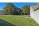 Large backyard with home's side elevation and patio at 4011 Lafayette Way, Loganville, GA 30052