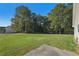 Large backyard with grassy area and trees at 4011 Lafayette Way, Loganville, GA 30052