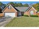 Brick house with two-car garage and well-manicured lawn at 4011 Lafayette Way, Loganville, GA 30052