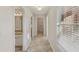 Clean hallway with tile flooring and access to bathroom and laundry at 4011 Lafayette Way, Loganville, GA 30052