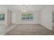 Well-lit dining room with carpeted floor and large window at 4011 Lafayette Way, Loganville, GA 30052