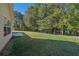 Large backyard with home's side elevation and patio at 4011 Lafayette Way, Loganville, GA 30052