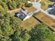 Aerial view of a house with a backyard and surrounding trees at 4011 Lafayette Way, Loganville, GA 30052