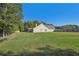 Large backyard with home's back elevation and fence at 4011 Lafayette Way, Loganville, GA 30052