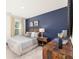 Serene bedroom with a blue accent wall, hardwood floors, and a comfortable bed at 619 Whitman (2200) Ln, Stockbridge, GA 30281