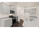 Modern kitchen with gray cabinets, granite countertops, and stainless steel appliances at 619 Whitman (2200) Ln, Stockbridge, GA 30281