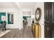 Bright entryway with gold console table, hardwood floors, and view into living area at 619 Whitman (2200) Ln, Stockbridge, GA 30281