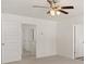 Well-lit bedroom with ceiling fan and access to hallway at 619 Whitman (2200) Ln, Stockbridge, GA 30281