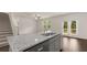 Kitchen island with granite countertop and gray cabinets, overlooking the living room at 619 Whitman (2200) Ln, Stockbridge, GA 30281