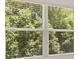 Window with blinds showcasing a view of lush greenery at 619 Whitman (2200) Ln, Stockbridge, GA 30281