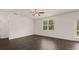 Spacious living room with dark hardwood floors and a ceiling fan at 619 Whitman (2200) Ln, Stockbridge, GA 30281