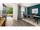 Dining area with hardwood floors, green accent wall, and view of backyard at 619 Whitman (2200) Ln, Stockbridge, GA 30281
