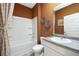 Clean bathroom with a tub/shower combo, gray vanity, and terracotta colored walls at 619 Whitman (2200) Ln, Stockbridge, GA 30281