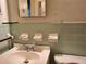 Bathroom sink with light green tile and mirror at 3102 Mckenzie Rd, Atlanta, GA 30344