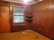 Small room with wood paneling, window, and shelves at 3102 Mckenzie Rd, Atlanta, GA 30344